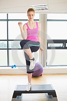 Woman performing step aerobics exercise