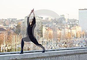 Woman performing yoga in city