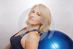 The woman performs a physical exercise to reduce weight