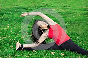 Woman Performs Side Bend in Park