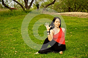 Woman Performs Sitting Sideways Twist in Park