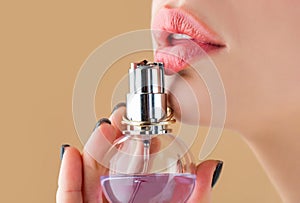 Woman perfumes bottle. Sexy lips. Pink lip. Close up of sexy plump soft lips with dark red lipstick. Beautiful girl