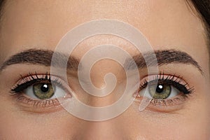 Woman with permanent makeup of eyes and brows, closeup