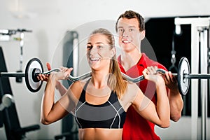 Woman with Personal Trainer in gym