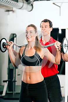 Woman with Personal Trainer in gym