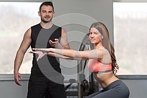 Woman With Personal Trainer Train On Bosu Ball