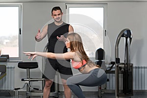 Woman With Personal Trainer Train On Bosu Ball