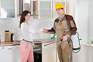 Woman And Pest Control Worker Shaking Hands