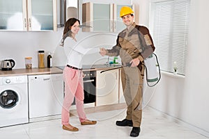Woman And Pest Control Worker Shaking Hands photo