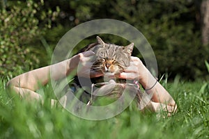 Woman petting cat in the garden