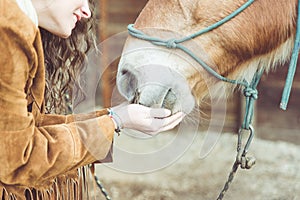 Woman petting her horse.