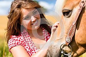 Woman petting horse - pony farm