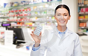 Woman pharmacist with pills drugstore or pharmacy
