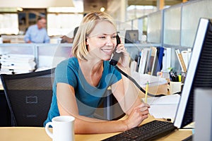 Woman On Phone In Busy Modern Office