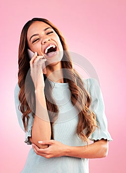 Woman, phone call and laugh with communication and technology, funny conversation on pink background. Happiness, young