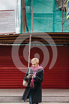 Woman with phone on city street