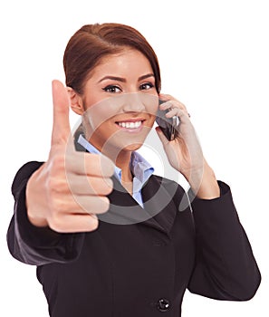 Woman with phone and thumbs up gesture
