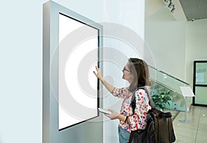 Woman with phone uses self-service desk