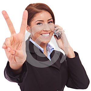 Woman with phone and victory gesture