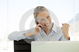 Woman on the phone at workplace - using mobile phone