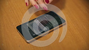 Woman phone writing sms on smartphone on table