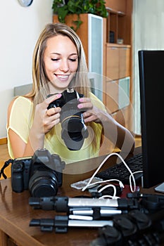 Woman with photocamera and laptop