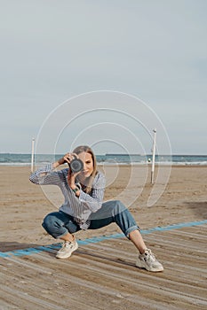 woman photographer on the beach with camera