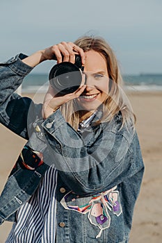 woman photographer on the beach with camera