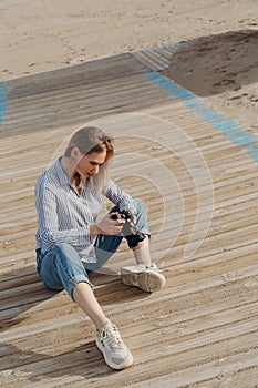 woman photographer on the beach with camera