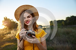 Woman photographer camera in hands smile red lips hat attractive look nature