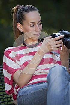 Woman photographer checking pictures