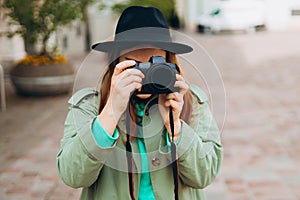 Woman photographer with dcamera taking pictures outdoor. Home hobby, lifestyle, travel, people concept. Portrait of a
