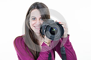 Woman photographer with a digital SLR camera in white background smiling