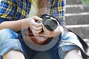 Woman, photographer hands and camera for travel picture sitting on garden steps. Journey, photo and photography of a