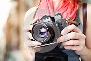 Woman photographer holding old 35mm film camera