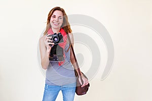 Woman photographer holding old 35mm film camera