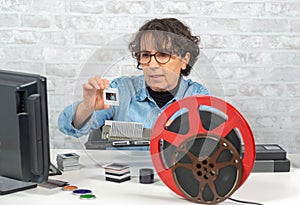 Woman photographer looking at film slide