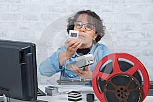 Woman photographer looking at film slide