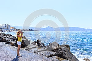 Woman photographer Nature photographer shooting the sea. Travel Concept