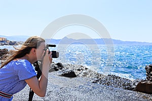 Woman photographer Nature photographer shooting the sea. Travel Concept