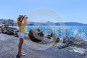 Woman photographer Nature photographer shooting the sea. Travel Concept