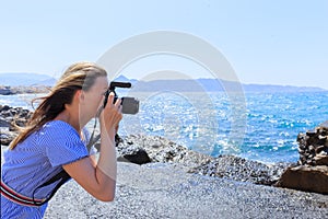 Woman photographer Nature photographer shooting the sea. Travel Concept