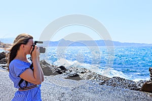 Woman photographer Nature photographer shooting the sea. Travel Concept