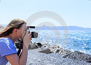 Woman photographer Nature photographer shooting the sea. Travel Concept