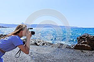 Woman photographer Nature photographer shooting the sea. Travel Concept