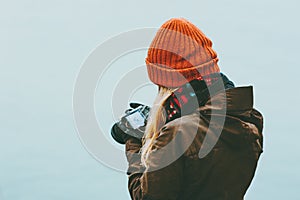 Woman photographer with photo camera foggy cold sea on background Travel Lifestyle concept adventure