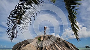 Woman photographer in Source d`Argent beach