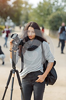 Woman photographer takes images with dslr camera