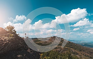 Woman photographer takes a picture of a mountain landscape on the camera