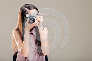 Woman photographer is taking images with dslr camera